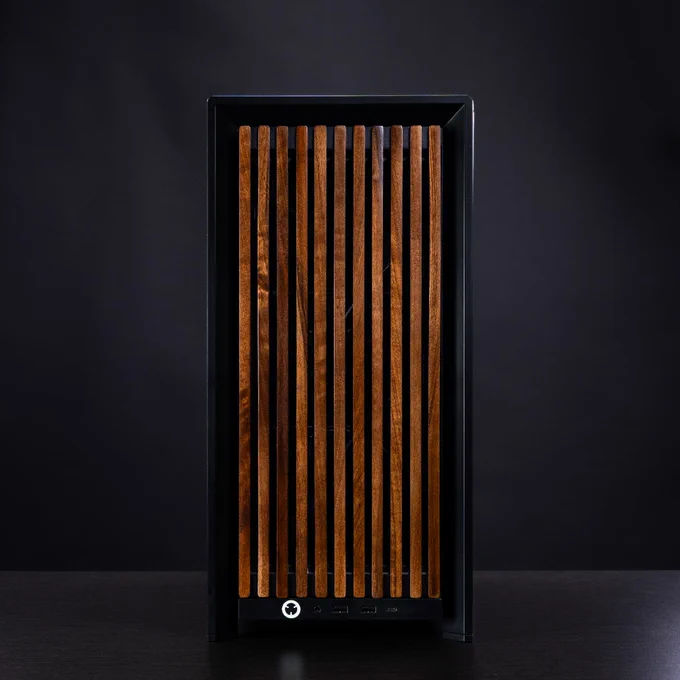 A dynamic image of an all black COrsair build, created in the FRAME Configurator.  The front panel is a dark wood aesthetic that offsets the solid black coloration.   