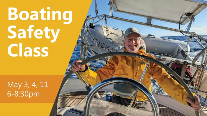 Capt. Michael Sacarny holds the ship's wheel on a boat.