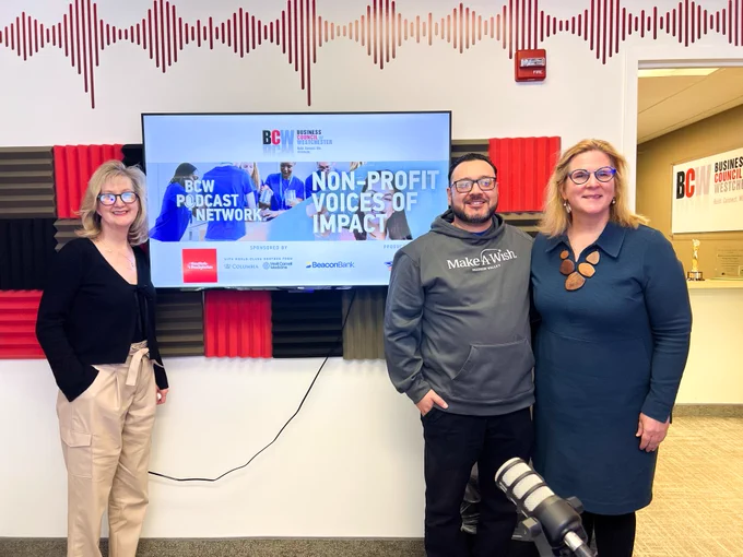 Group photo of three people standing in a recording studio.