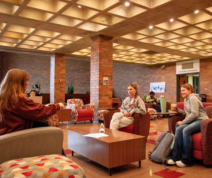 Students hanging out in Skou Lounge catching up and drinking coffee. 