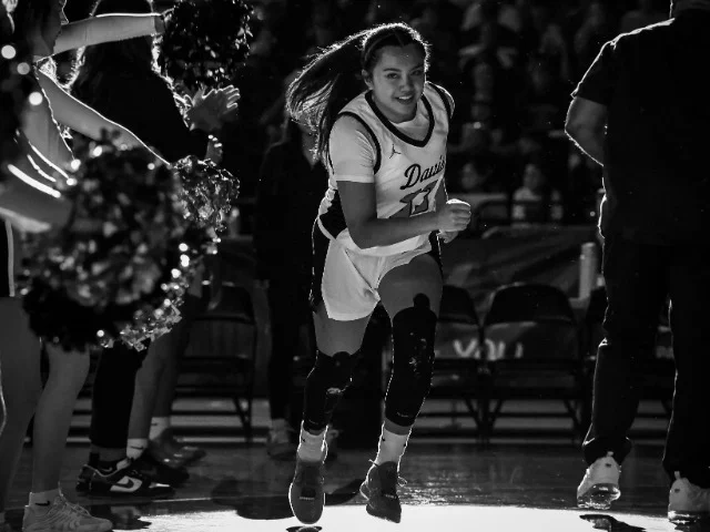 A black and white photo of Isa Garcia running on the court