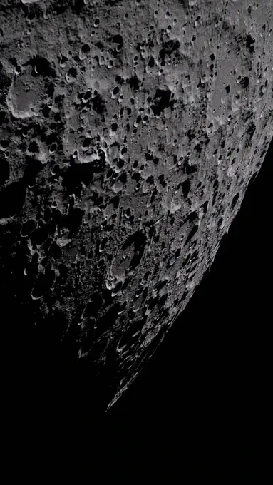 A closeup on the far side of the Moon reveals a heavily cratered, deep gray surface. Credit: NASA
