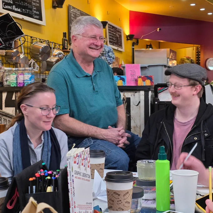 This is a photo of SnoCo DSA members at the crafts with comrades event surrounded by art supplies.