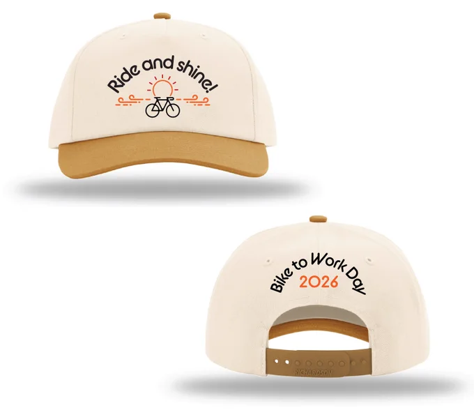 The image shows two views of a beige baseball cap. The front view features the text "Bike to Work Day 2026". The back view features the text "Bike to Work Day 2026". The cap has a brown brim and has an adjustable strap.
