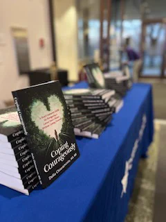 Coping Courageously: A Heart-Centered Guide for Navigating a Loved One’s Illness Without Losing Yourself by Dr. Delia Chiaramonte. 