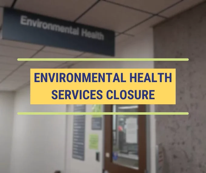 Sign about Environmental Health Services closure with a blurred image of the front desk that will be closed in the background.