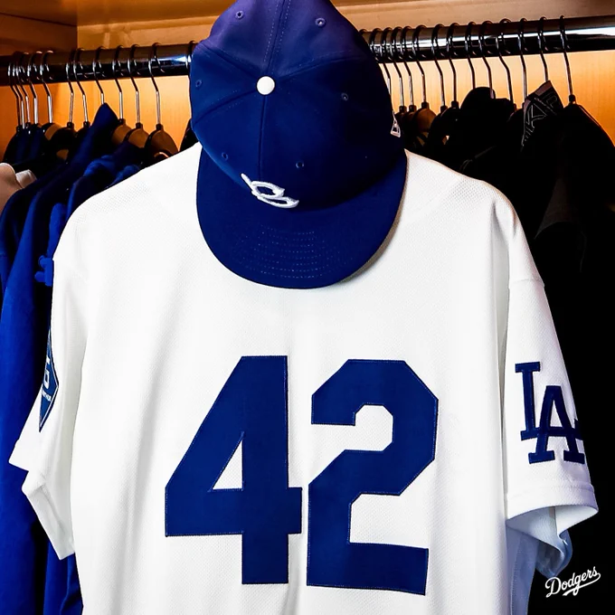 A photo of the 42 jersey in honor of Jackie Robinson Day with the Brooklyn hat hanging on top of it.