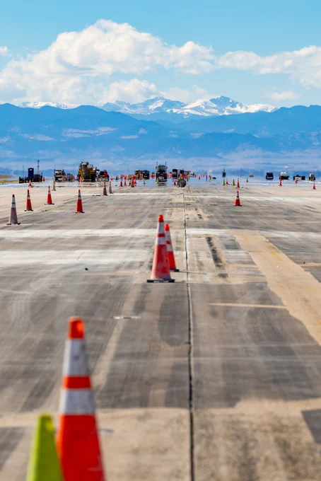 Construction equipment and cones line Runway 7/25 at DEN.
