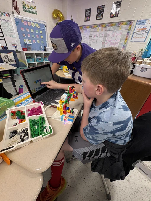 2 boys working on building a spike lego ferris wheel.