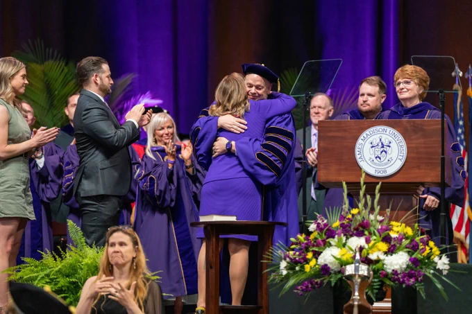 President Jim hugs his wife, First Lady Kim Schmidt after he is presented with the Presidential Chain of Office.