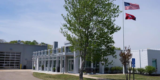 Exterior of TCAT Crump's Parsons campus. Tennessee state flags fly from the flagpole. 