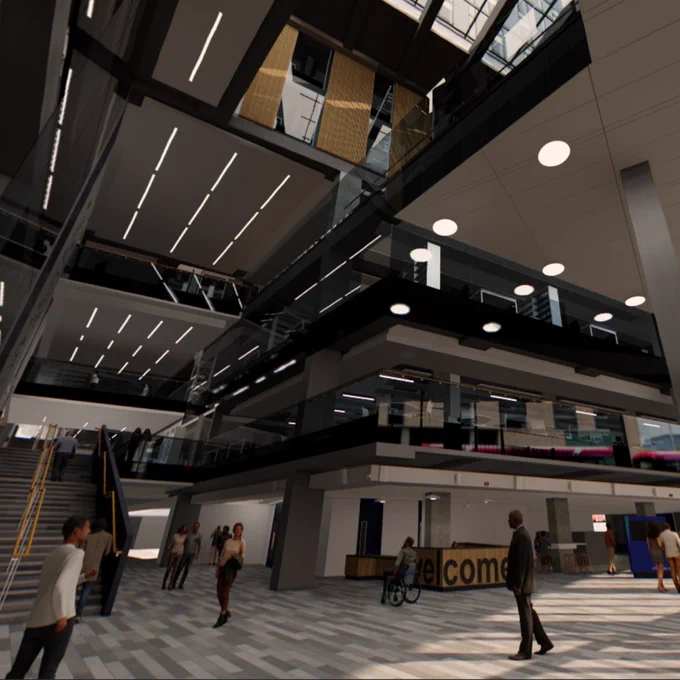 Spacious modern reception with multiple glass balconies, people walking, and a welcome desk near the entrance.