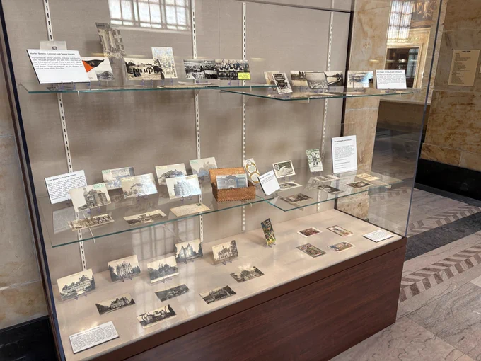 Display case full of postcards. 