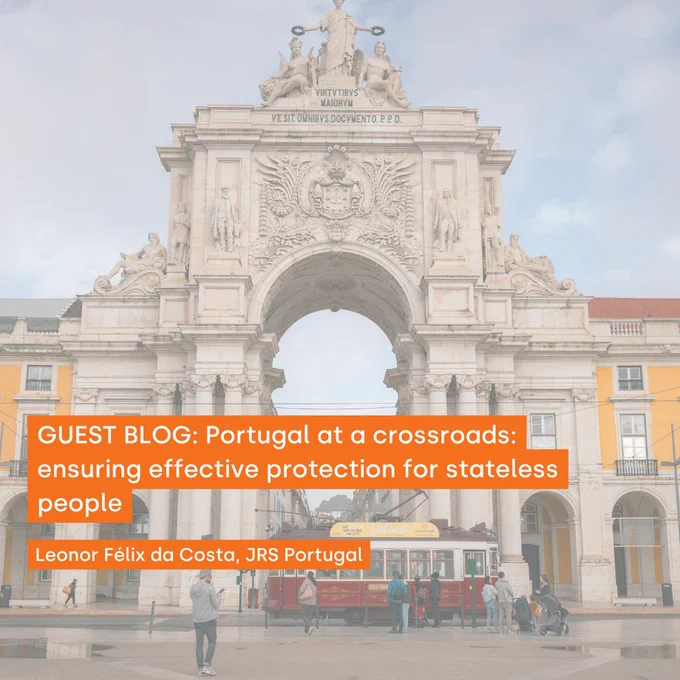 Text reads: 'GUEST BLOG: Portugal at a crossroads: ensuring effective protection for stateless people. Leonor Felix da Costa, JRS Portugal'. In white text on an orange background. Behind the text, faded, is an archway in Lisbon with a tram passing below it, and some people in the street.