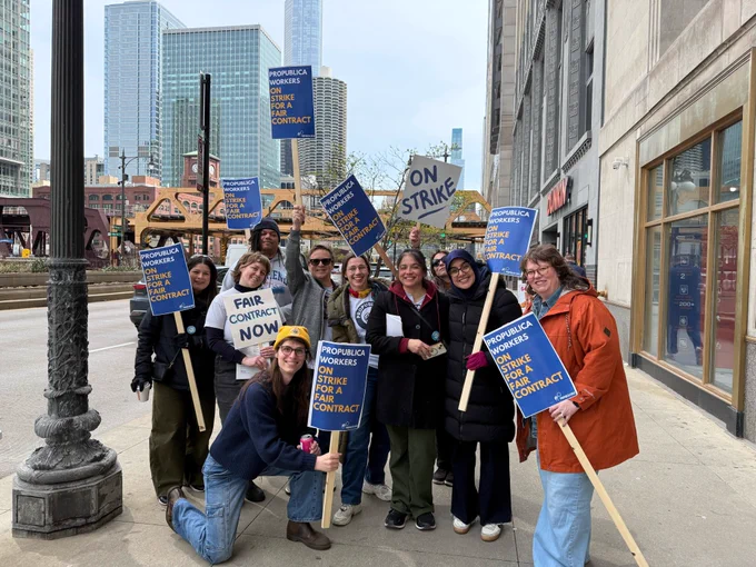 A group of 10 people pose for a photo while holding signs that say "ProPublica workers on strike for a fair contract."