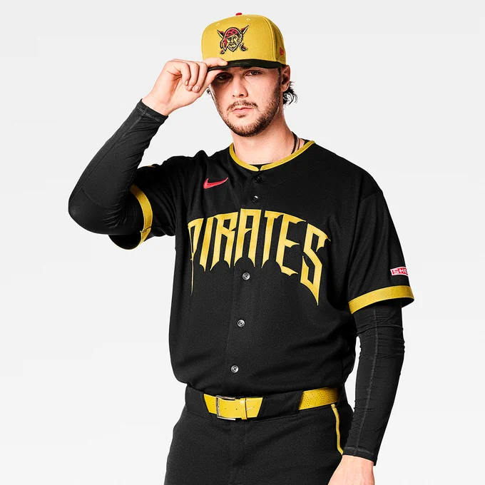 Paul Skenes posing for a photo in the new Pirates City Connect uniform. He’s touching the brim of his hat with his right hand.