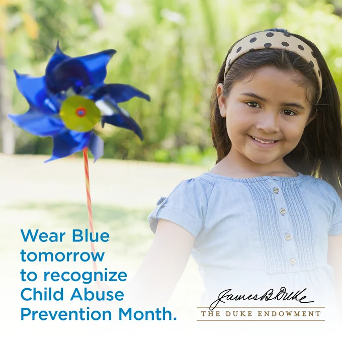 A child holding a blue pinwheel is smiling outdoors. Text on the image reads, "Wear Blue tomorrow to recognize Child Abuse Prevention Month." The Duke Endowment logo is at the bottom.
