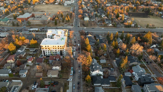 An aerial view of an Edmonton street at rush hour, showing multiple lanes of traffic and nearby buildings.