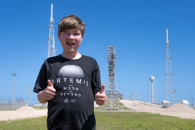 Young boy giving thumbs up at Launch Complex 39B.