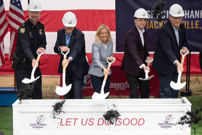 mayor deegan and four other people shoveling dirt at the tunnel to towers veterans village groundbreaking