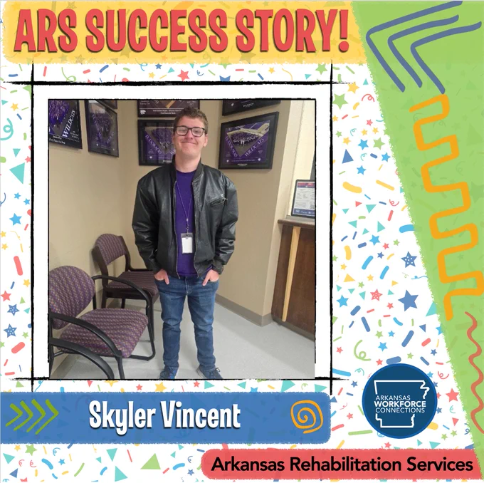 Skyler Vincent stands smiling for the camera at his workplace.