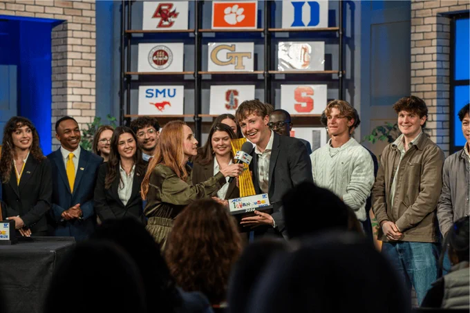 FSU student Hugo Davies accepts People's Choice Award at the ACC InVenture Prize competition surrounded by other competitors.