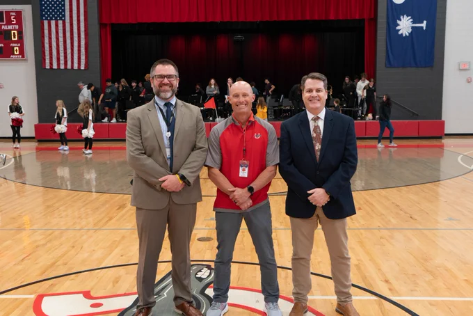 Staff members and a representative from the South Carolina Association for Middle Level Education during an assembly at Palmetto Middle School to honor the school for its 6th Schools to Watch redesignation. 