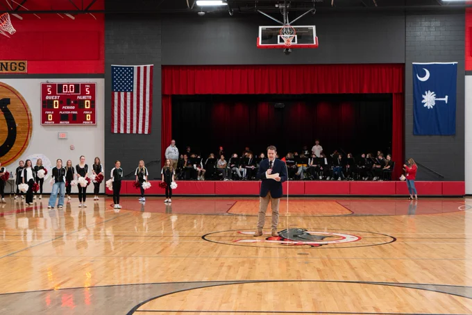 A representative from the South Carolina Association for Middle Level Education spoke during an assembly at Palmetto Middle School to honor the school for its 6th Schools to Watch redesignation. 
