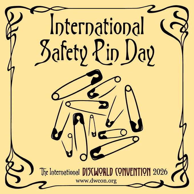 Pale yellow square background with black art nouveau border and text reading "International Safety Pin Day".  Below it sits a black outline drawing of scattered safety pins