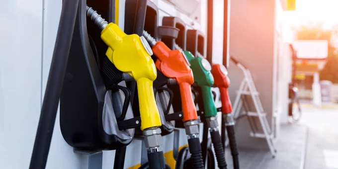 Image shows four fuel pumps at a petrol station.