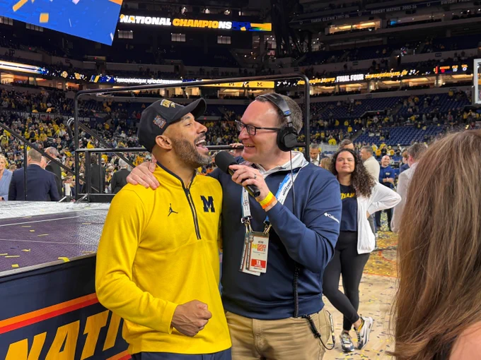 Brian Boesch interviews Michigan assistant coach Justin Joyner after the men's basketball team won the National Championship.