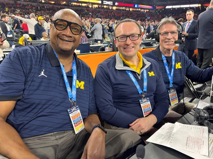 Brian Boesch, middle, with his broadcast crew take a selfie before the National Championship game. All are wearing Michigan gear and passes. 