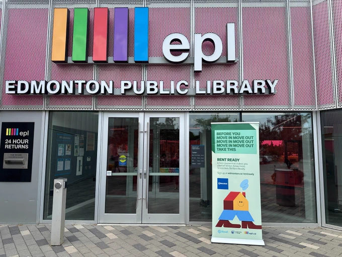 A Rent Ready branded pull-up banner sits to the right of the front doors of the Calder Edmonton Public Library.
