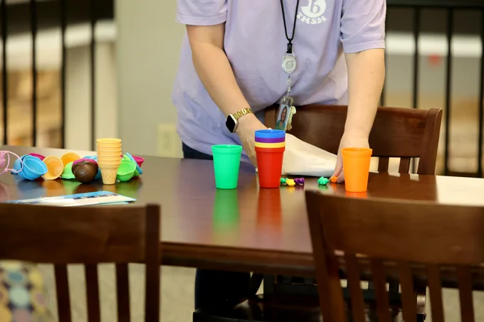 Literacy team member placing game elements on table for event