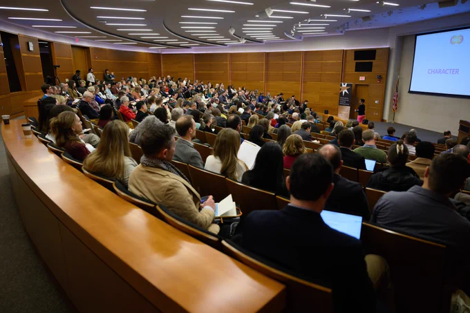 Wide shot of people in a conference session at Wake Forest University.