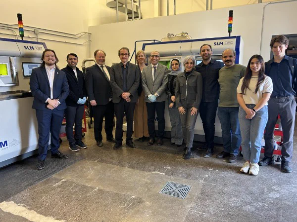 IMAGE: Group portrait showing Alejandro Adem and Anne-Marie Thompson, accompanied by representatives from University of New Brunswick, in a laboratory. 