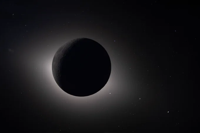 A photo of the Moon fully eclipsing the Sun, with distant stars in the background.