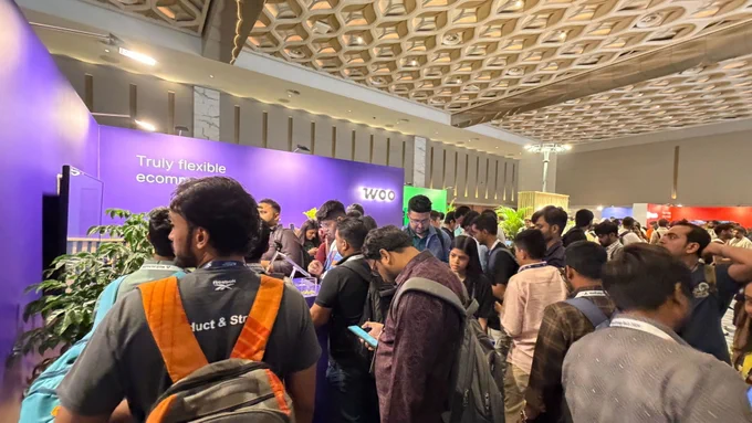 A crowd gathers in front of the Woo booth at WordCamp Asia 2026.