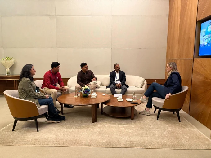 A group gathered around the table, talking.