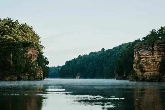 forested cliffs along a river