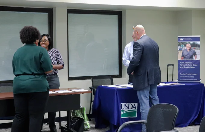 Attending members of local communities talk to various state and federal agency representatives that offer funding opportunities for community development projects.