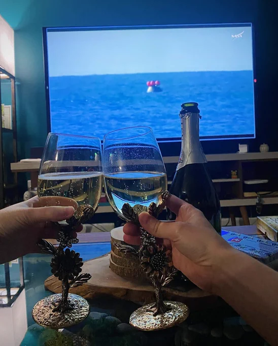 Cheering my partner with a drink in front of a livestream of the Artemis II landing 