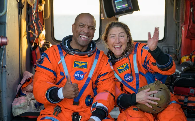 NASA astronaut Victor Glover, Artemis II pilot, left, and NASA astronaut Christina Koch, Artemis II mission specialist are seen sitting on a Navy MH-60 Seahawk from Helicopter Sea Combat Squadron (HSC) 23 on the flight deck of USS John P. Murtha after they and fellow crewmates CSA (Canadian Space Agency) astronaut Jeremy Hansen, Artemis II mission specialist, and NASA astronaut Reid Wiseman, Artemis II commander, were extracted from their Orion spacecraft after splashdown, Friday, April 10, 2026, in the Pacific Ocean off the coast of California. NASA\u2019s Artemis II mission took the quartet on a nearly 10-day journey around the Moon and back to Earth. Following a splashdown at 5:07 p.m. PDT (8:07 p.m. EDT), NASA, U.S. Navy, and U.S. Air Force teams are working to bring the Orion spacecraft aboard the recovery ship. Credit: NASA/Bill Ingalls