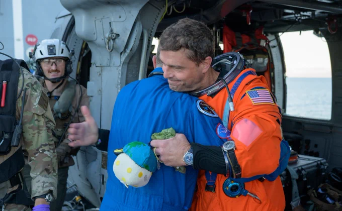 NASA astronaut Reid Wiseman is hugging NASA Flight Surgeon Richard Scheuring on the flight deck of USS John P. Murtha, following the extraction from the Orion spacecraft after splashdown, on Friday, April 10, 2026. Photo credit: NASA/Bill Ingalls.