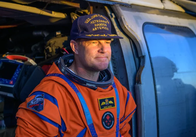 Canadian astronaut Jeremy Hansen is sitting in a Navy MH-60 Seahawk from Helicopter Sea Combat Squadron (HSC) 23 on the flight deck of USS John P. Murtha, following the extraction from the Orion spacecraft after splashdown, on Friday, April 10, 2026. Photo credit: NASA/Bill Ingalls.