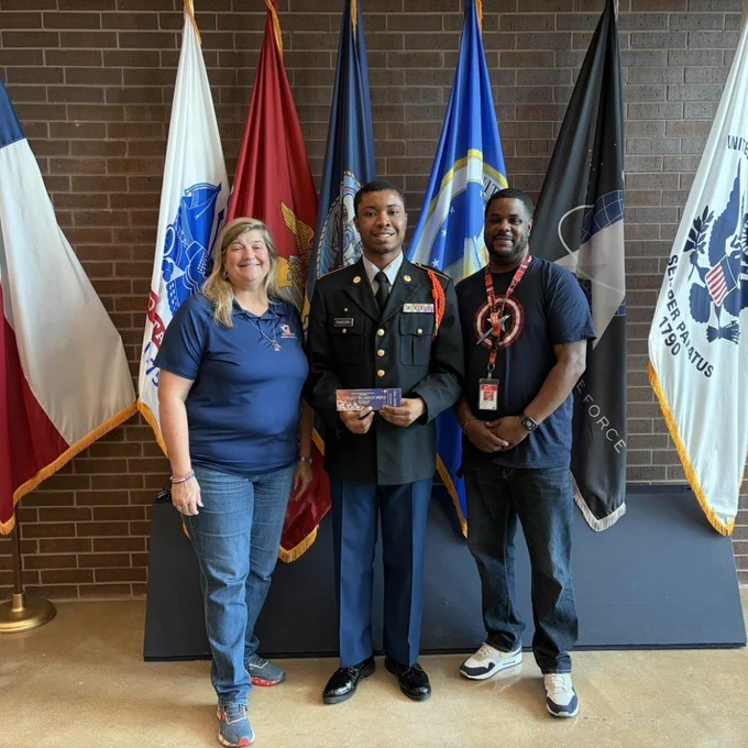 Anthony Ohaegbu stands with Dr. Arredondo and Mr. Brown with his prom ticket