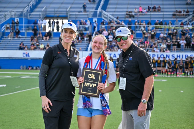 Tyler Weaver poses with MVP plaque and UIL staff. 