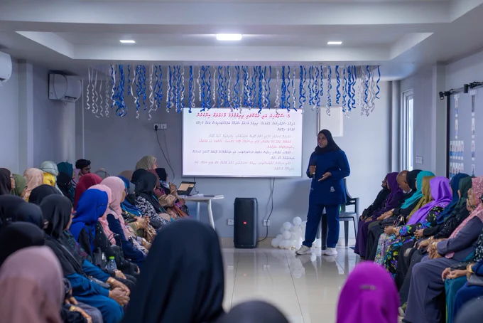 Picture of a nurse in scrubs taking a session for elderly