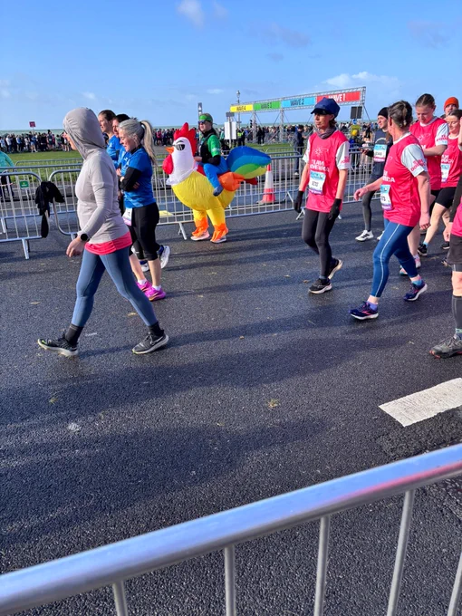 A photograph of a Samaritans volunteer dressed in a chicken outfit running in the Brighton marathon
