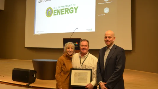 William Nichols, center, receives the Outstanding Security Professional award from Argonne Chief Security Officer Dan Walsh, right. Wife Lynn Nichols stands to William’s right. 